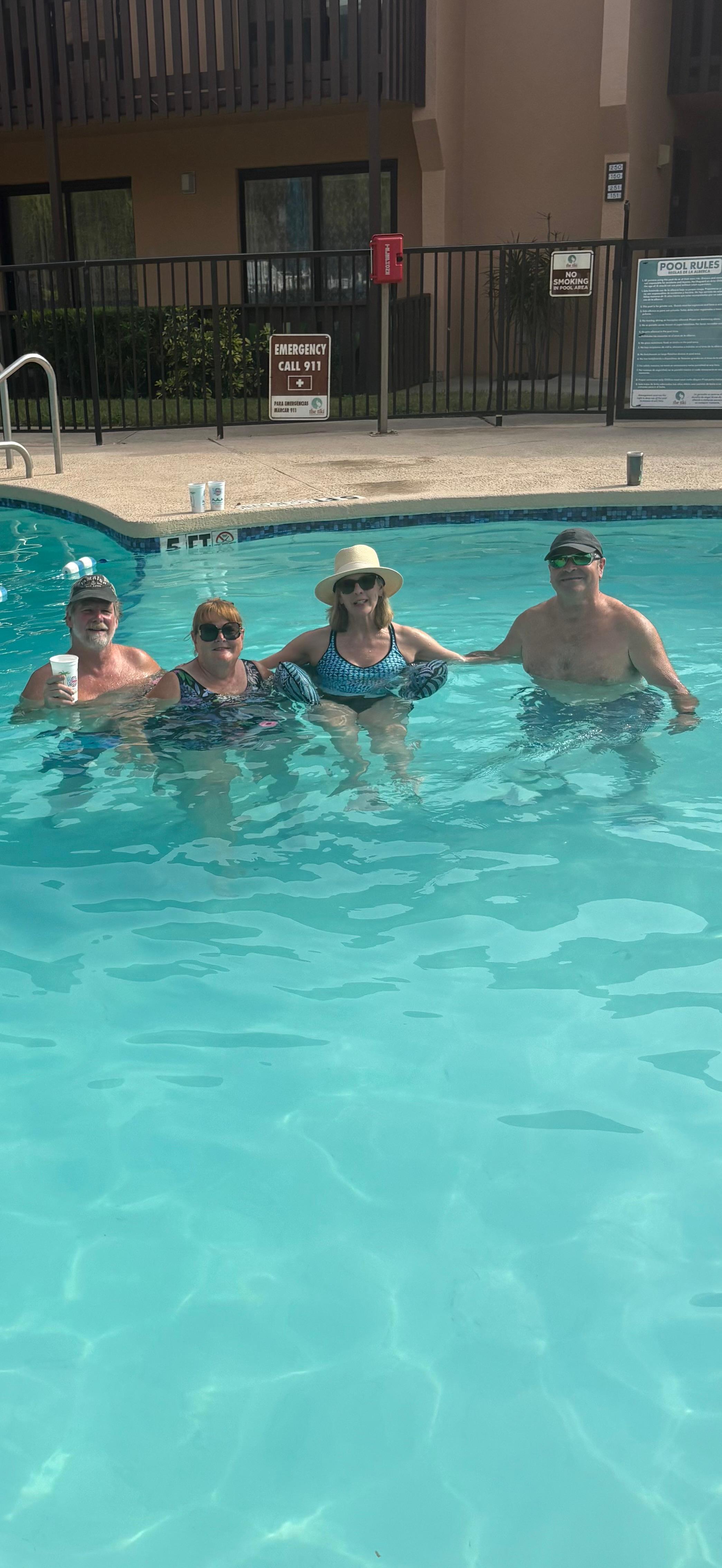 Swimming/floating in the pool. 
