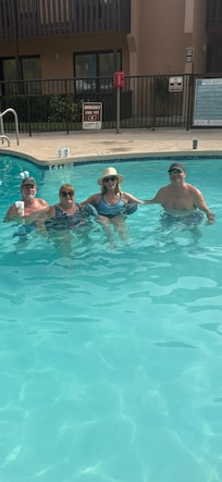 Swimming/floating in the pool.