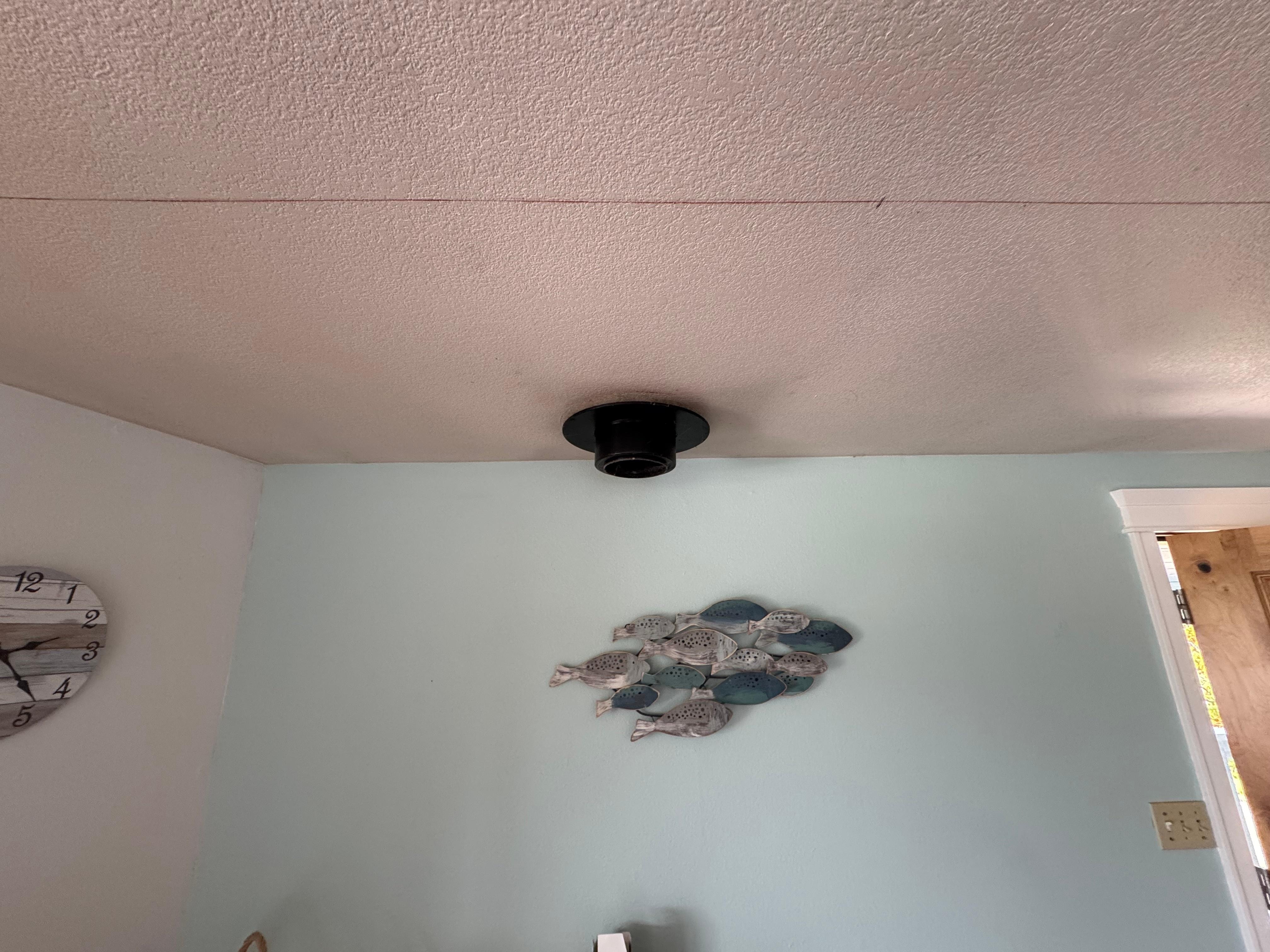 The hole in the ceiling for the chimney of a stove that has been replaced (and a red 'construction line' on the ceiling)