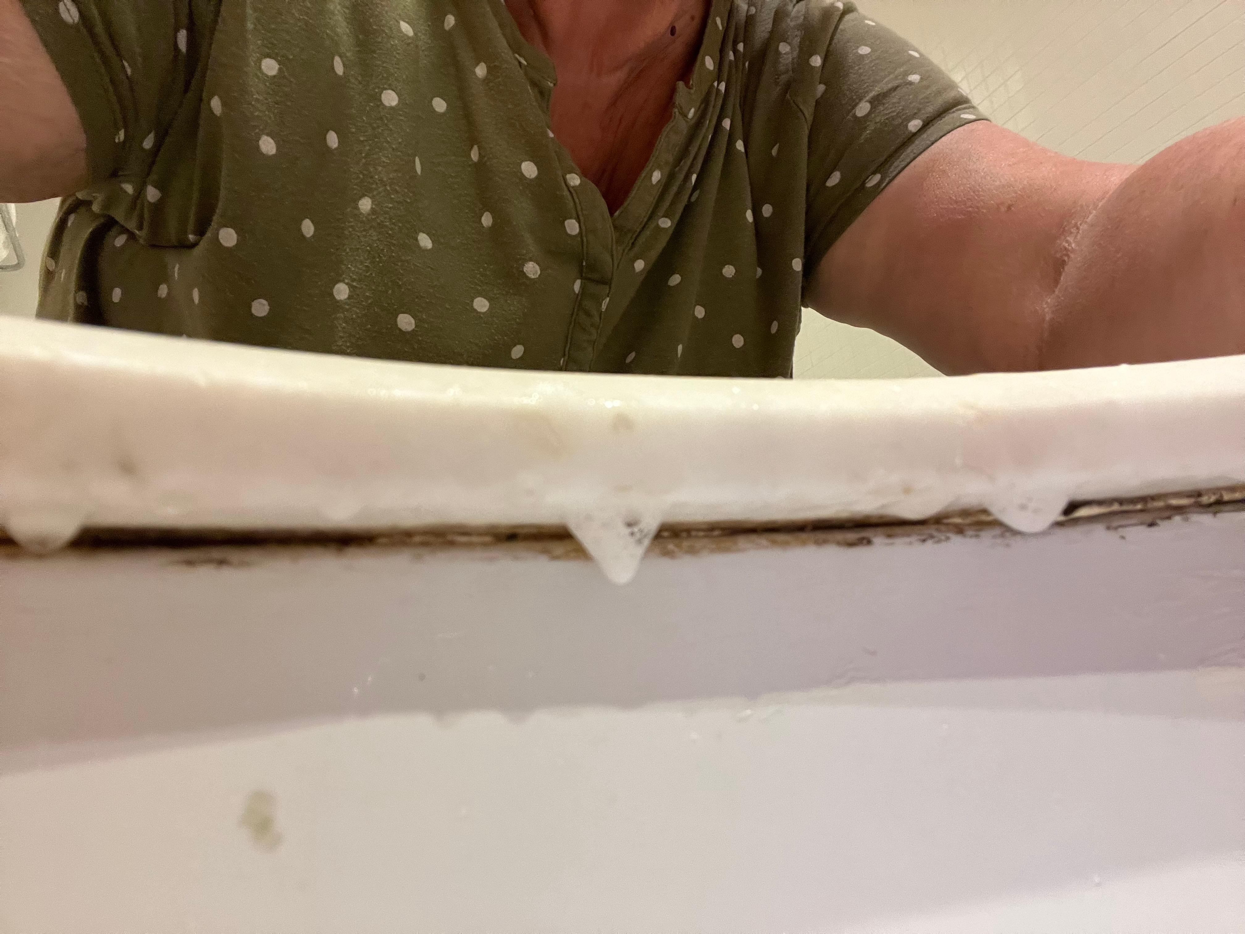 Under the rim of the sink