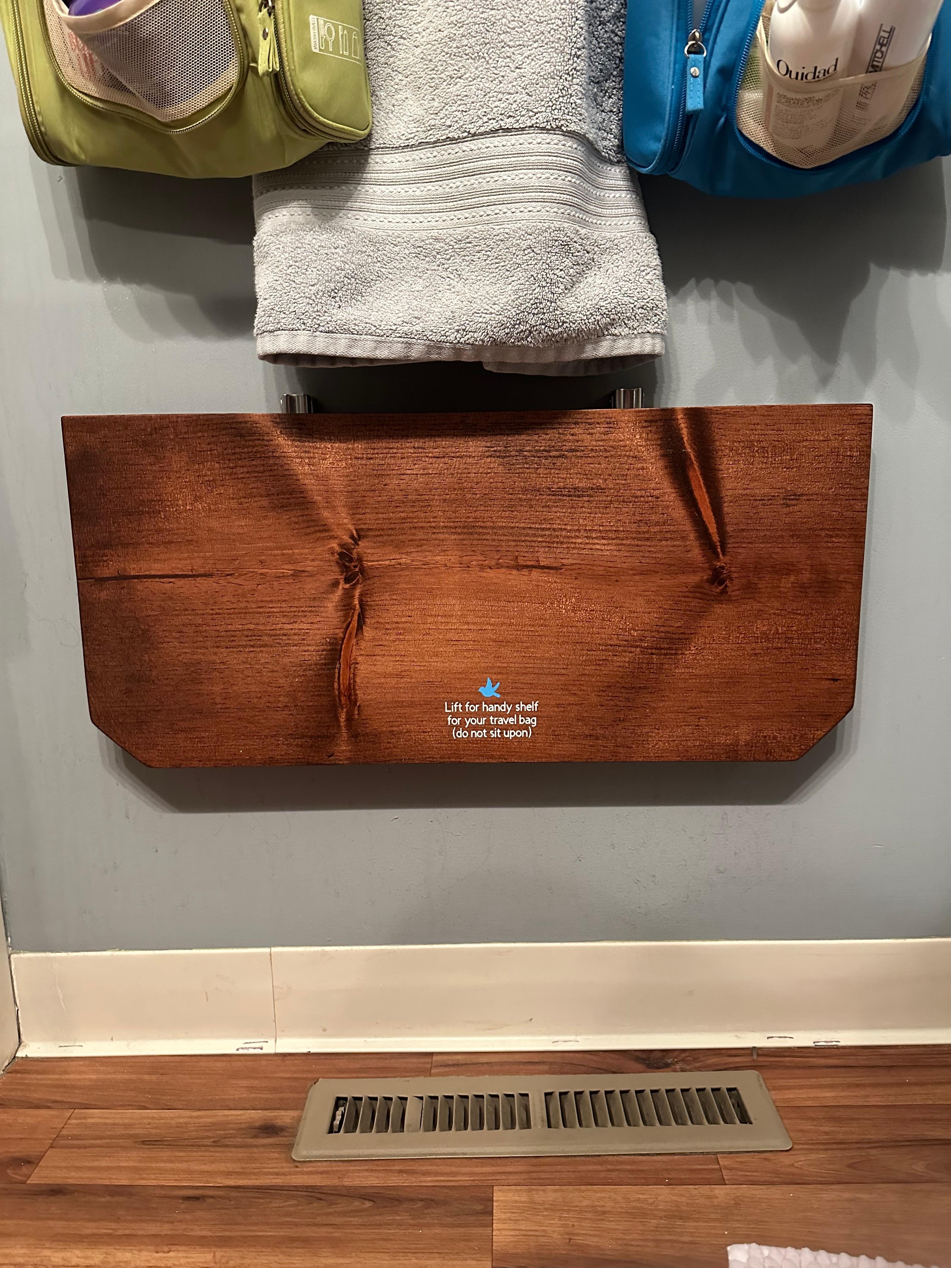 I thought this shelf in the bathroom was such a great idea. It pops up if you need it, and you can put it flat again when you don't.