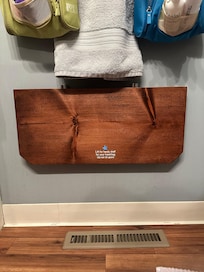 I thought this shelf in the bathroom was such a great idea. It pops up if you need it, and you can put it flat again when you don't.