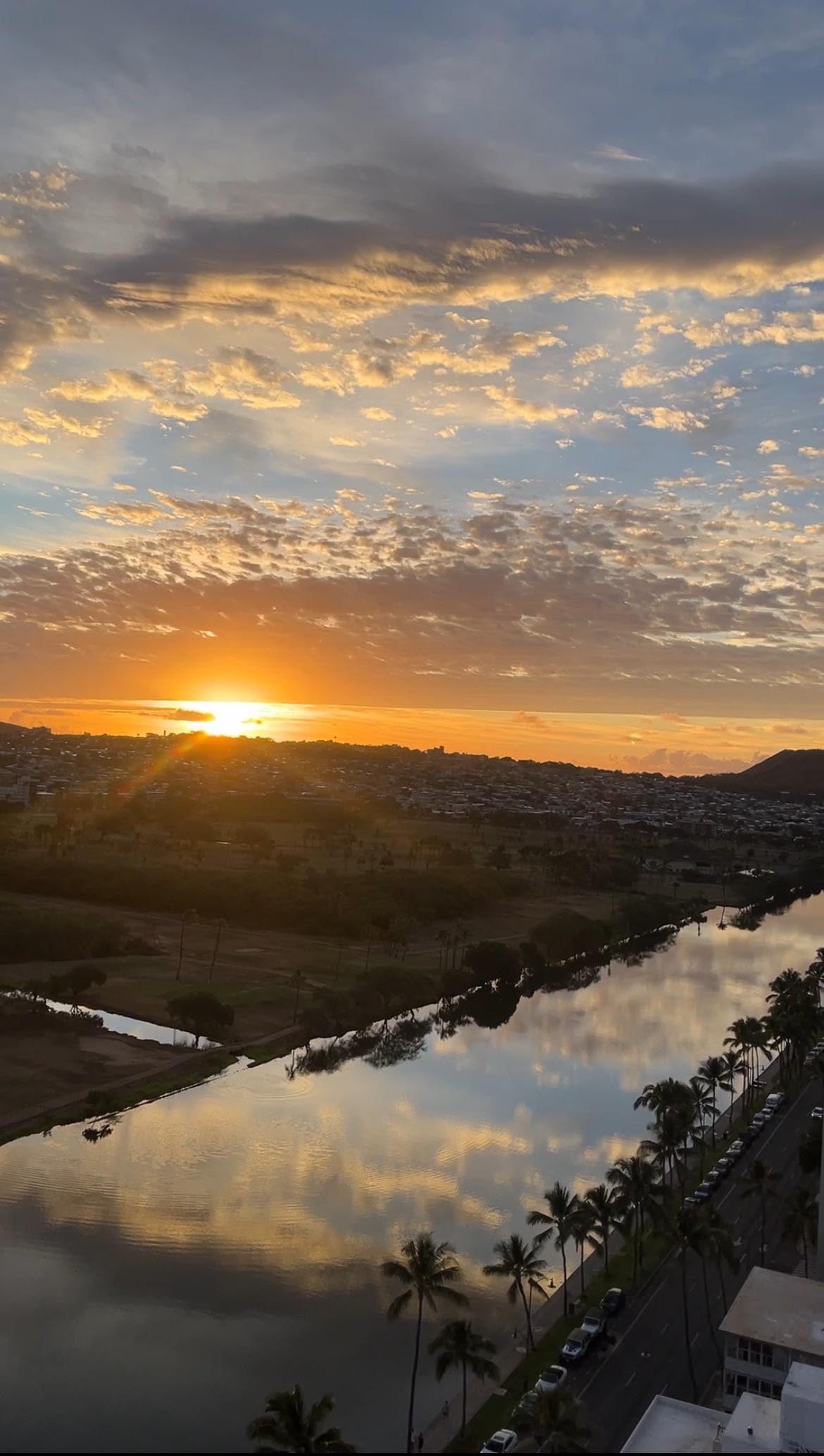 Sun rise on the balcony, to the right is the Diamond Head State Monument and the Ala Wai Canal.