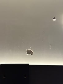 Hole in wall caused by punch