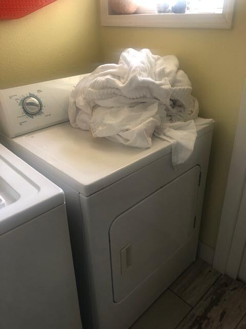 Dirty laundry on top of dryer, sheets dirty from previous occupants. We folded the laundry that was in the dryer. 