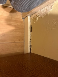 Sheetrock and floorboard in bathroom