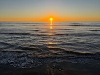 Walk down the steps at sunset and be on the beach