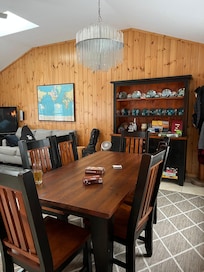 Large dining room table as well as picnic table by sliding doors.