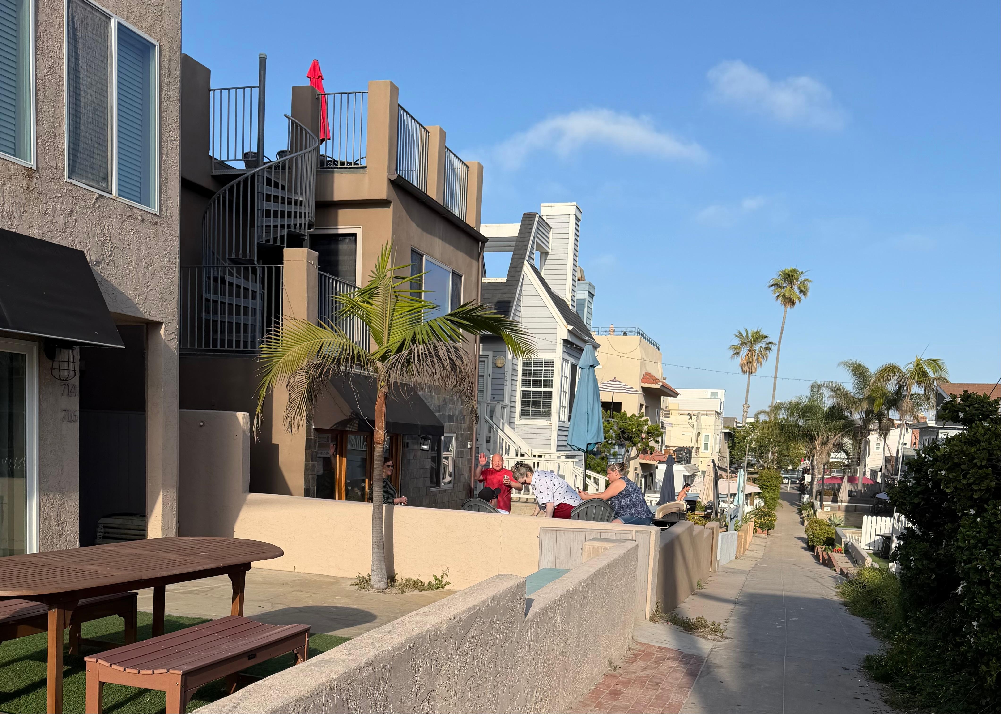 House is located on left with blue umbrella 