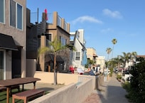 House is located on left with blue umbrella