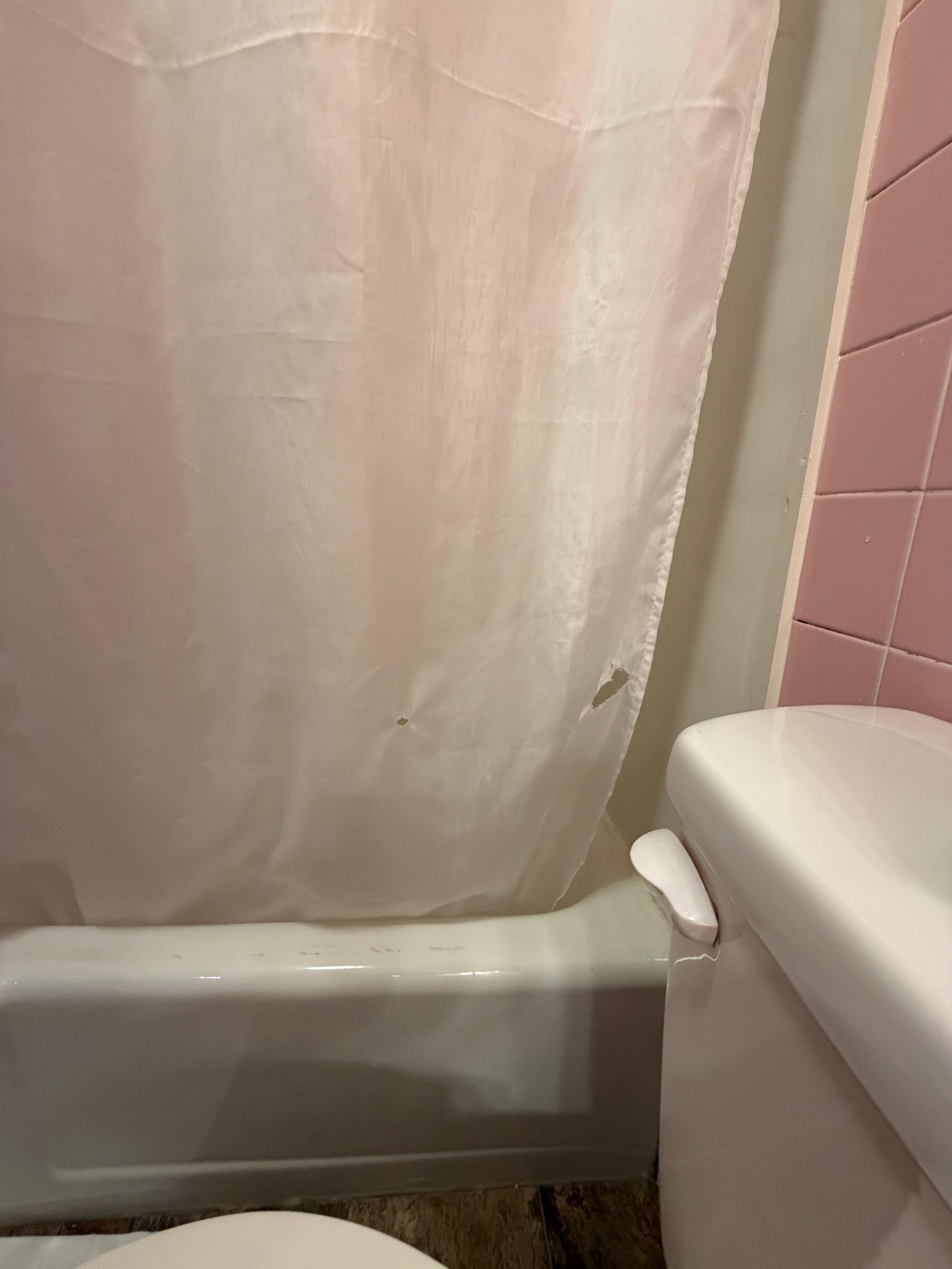 Burnt holes in the shower curtain