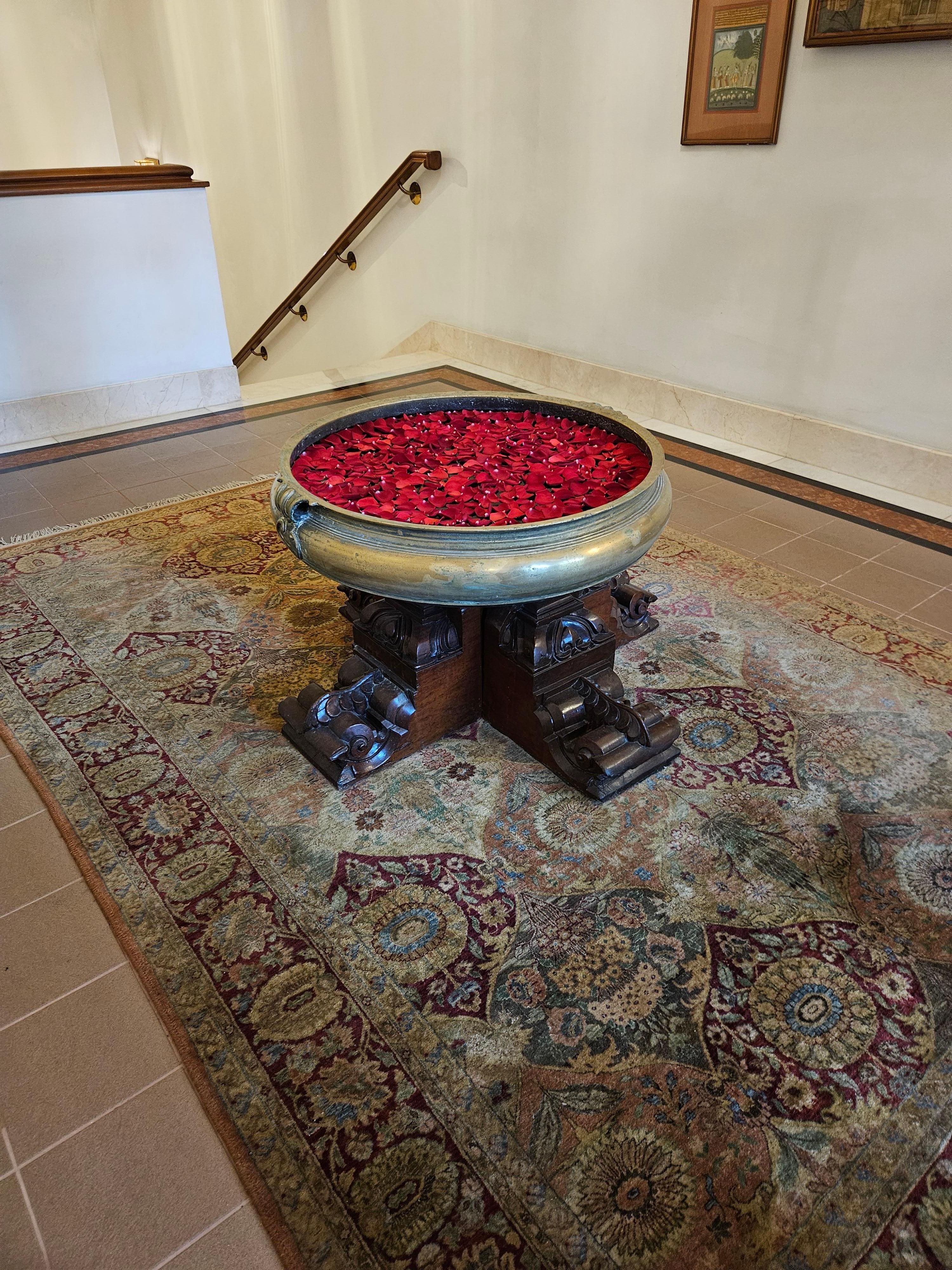 Beautiful antique Urli with floating fresh rose petals greeting you at the spa/fitness center.