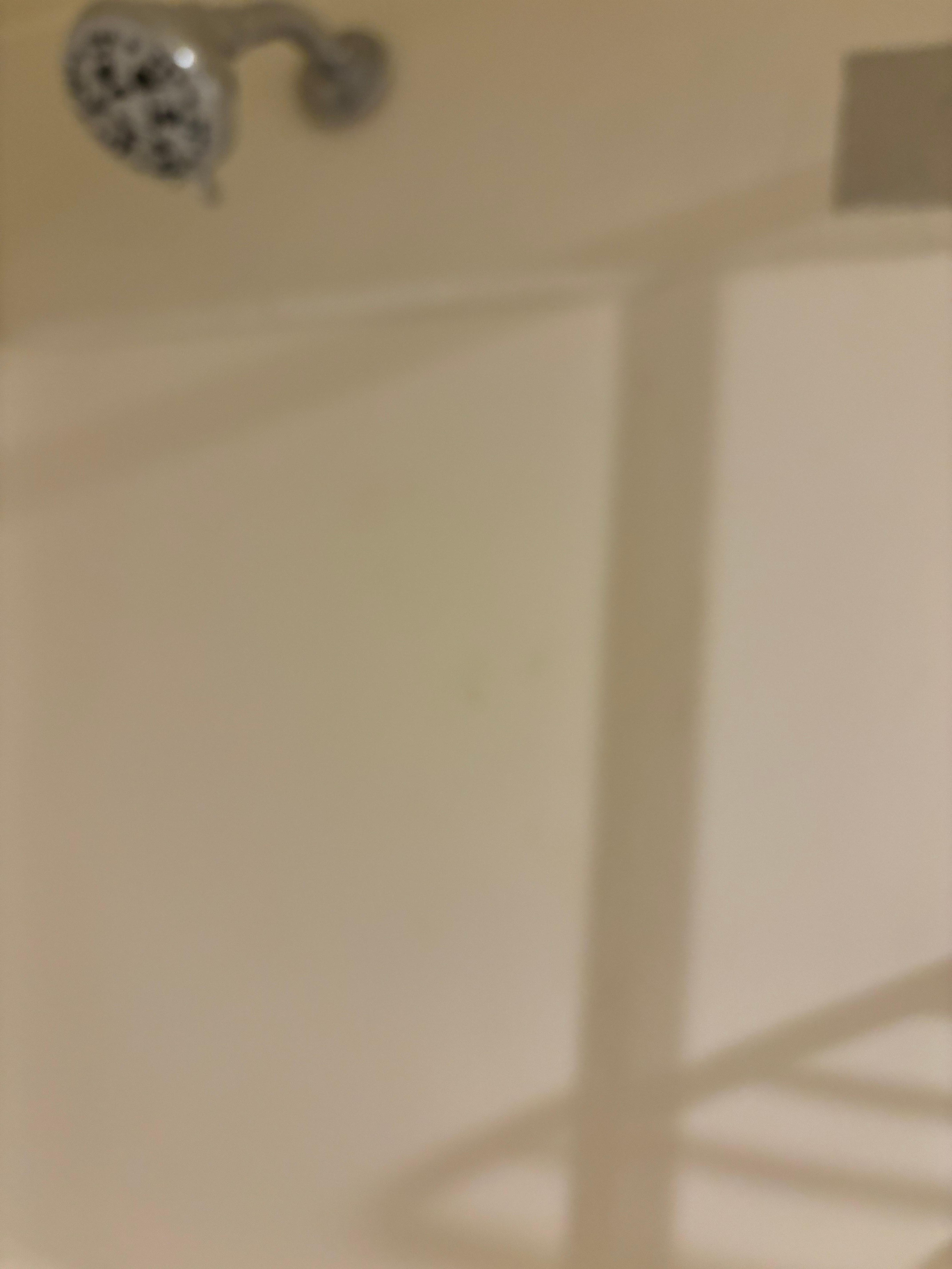 Dirt on shower walls. 