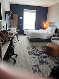 The room was spacious and included a refrigerator, microwave, plates, utensils and glasses.glasses