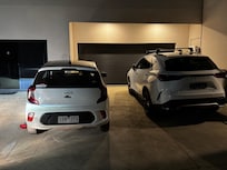 Cars parked not in the parking spaces blocking access