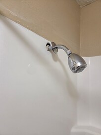 Shower head broken free from the wall