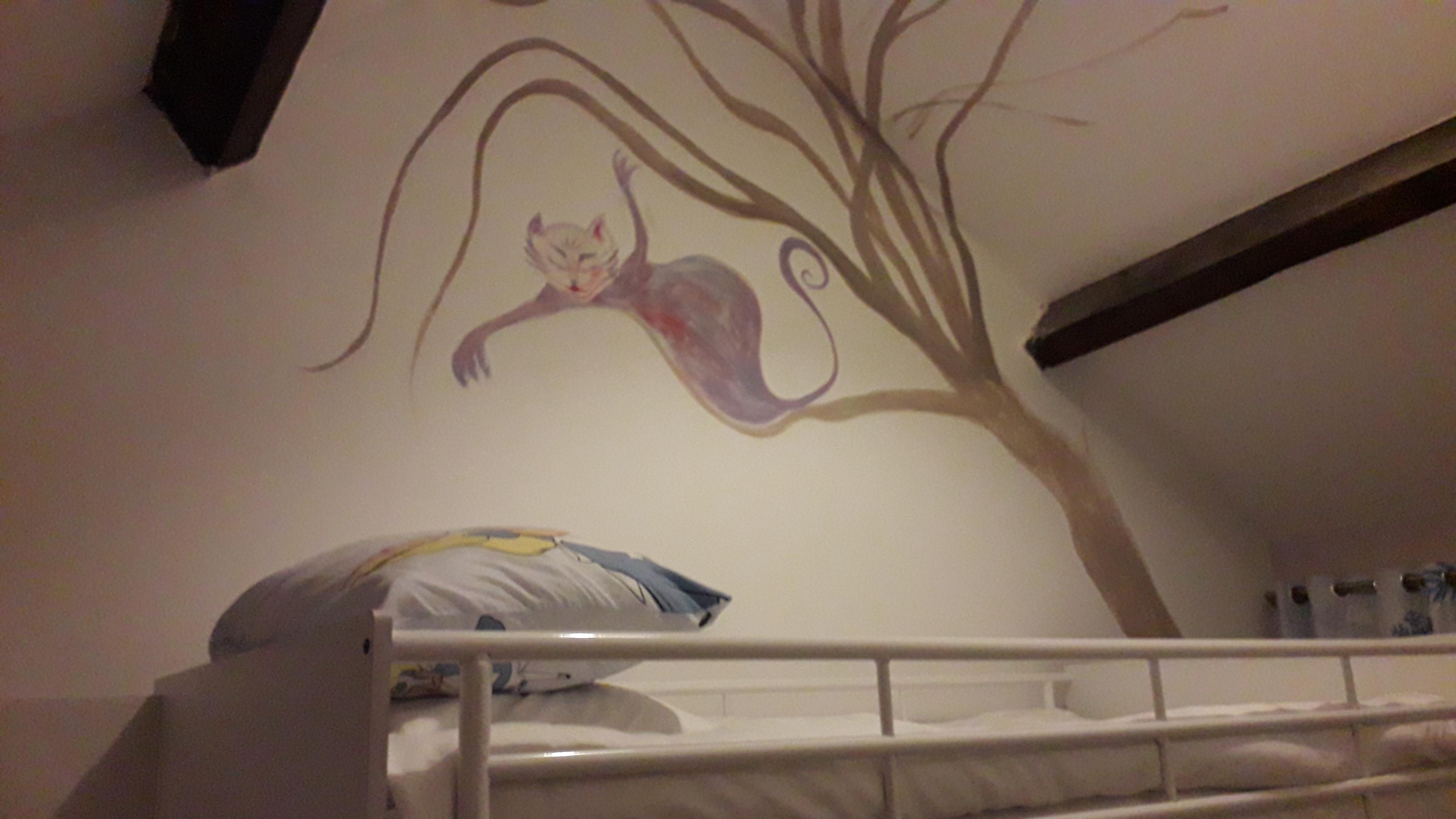 Bunk beds with Cheshire cat painted on walls