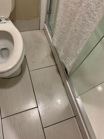 Dirty footprints on floor after using the shower. The dirt was on the floor - my feet were clean.