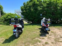 Two mopeds with rear storage