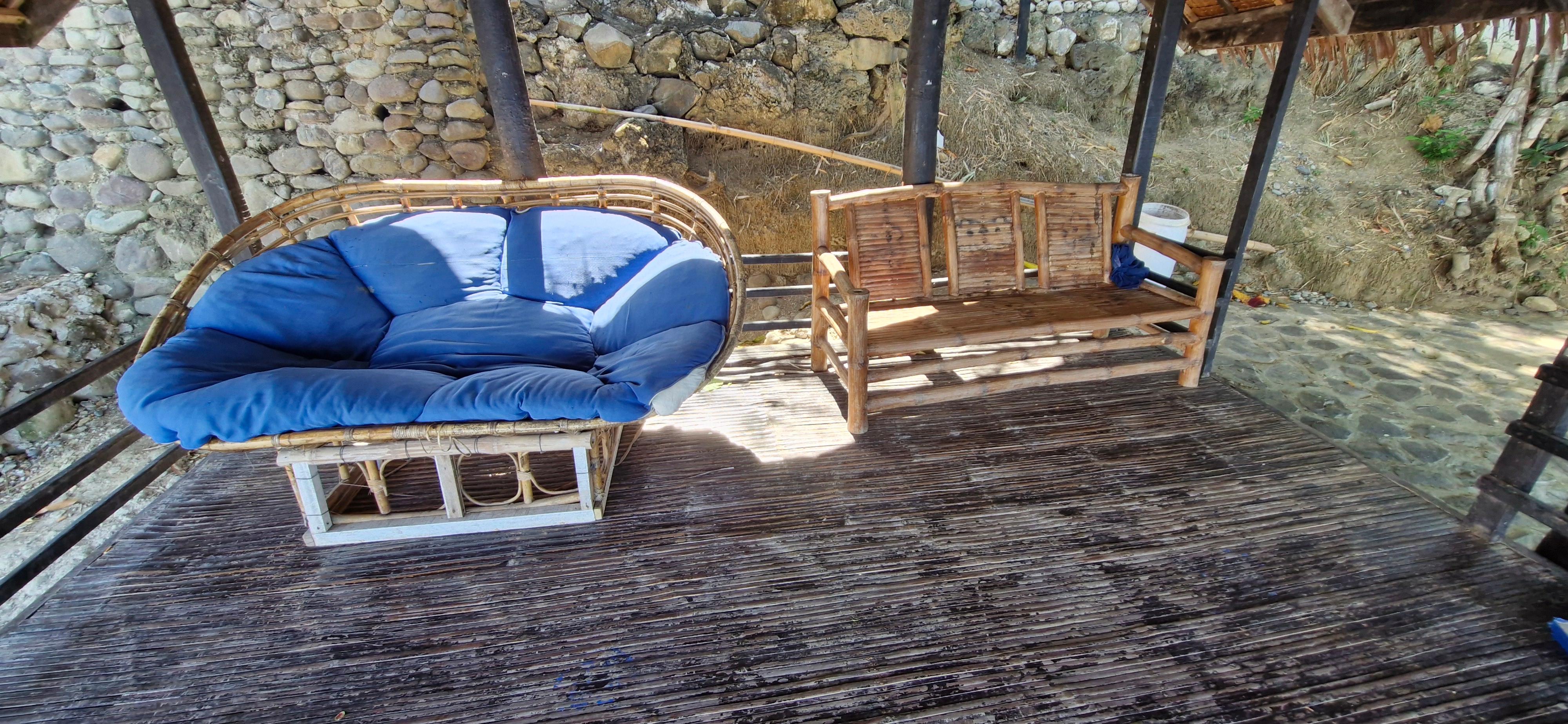 Gazebo with hole in the floor and dirty sofa.