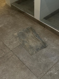 Bath mat in communal showers. I think it’s meant to be white!
