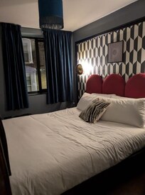 We did have to hide in the corner to not be in the picture--lovely queen sized bed and enough room for two bedside tables and a hanging rail, but expect to be touching the wall when you slide across the foot of the bed to the other side. :)