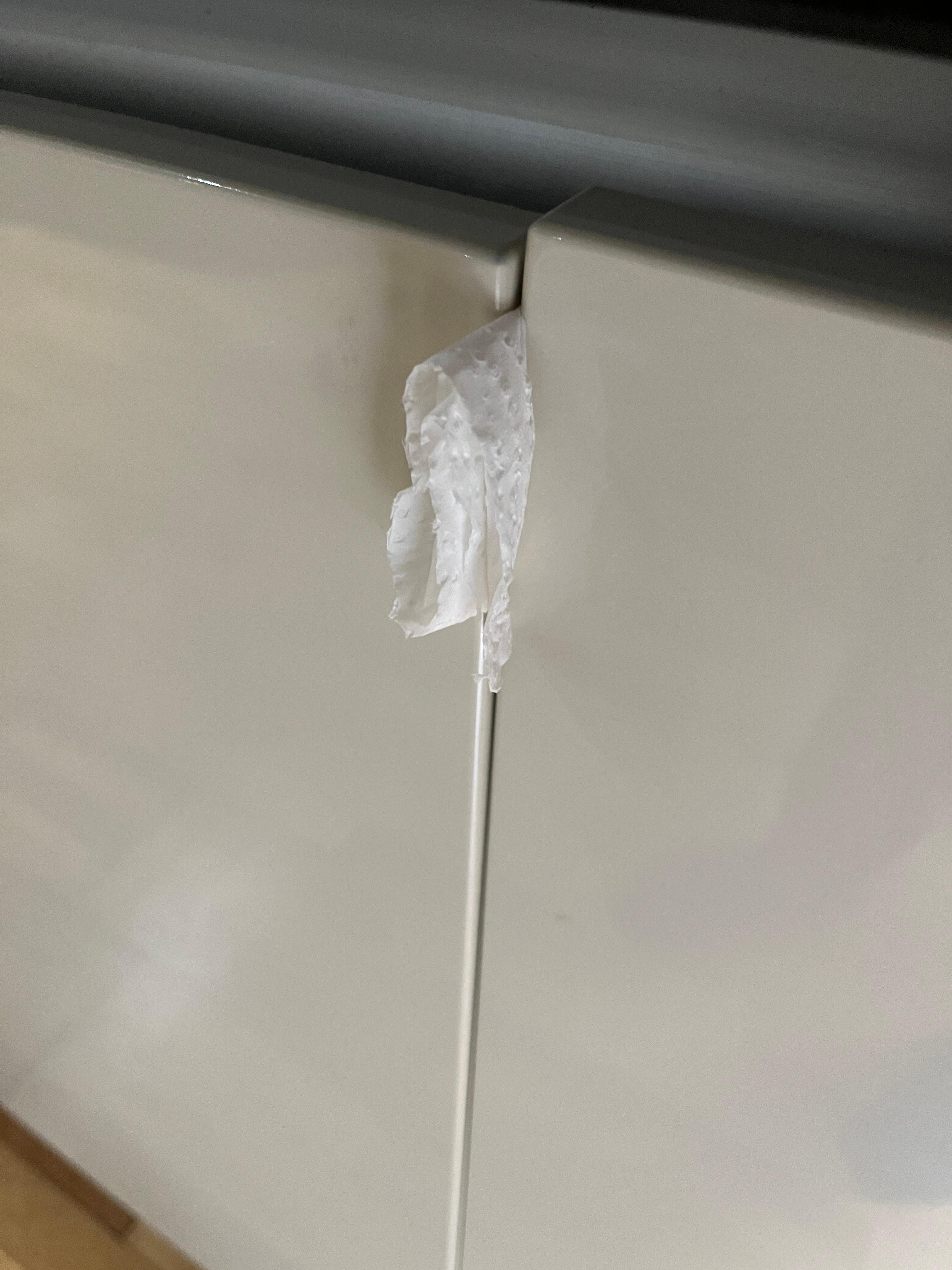 Fridge door won’t stay closed, so maintenance man “FIXED” it with tissue paper!!