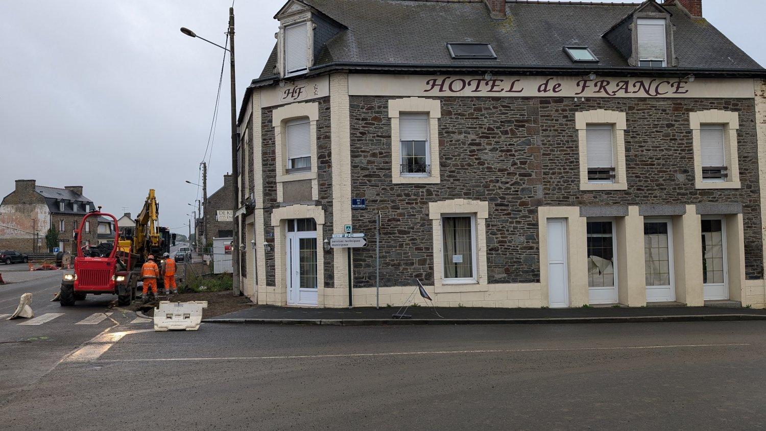 Workmen digging up the pavement outside the reception (only) door