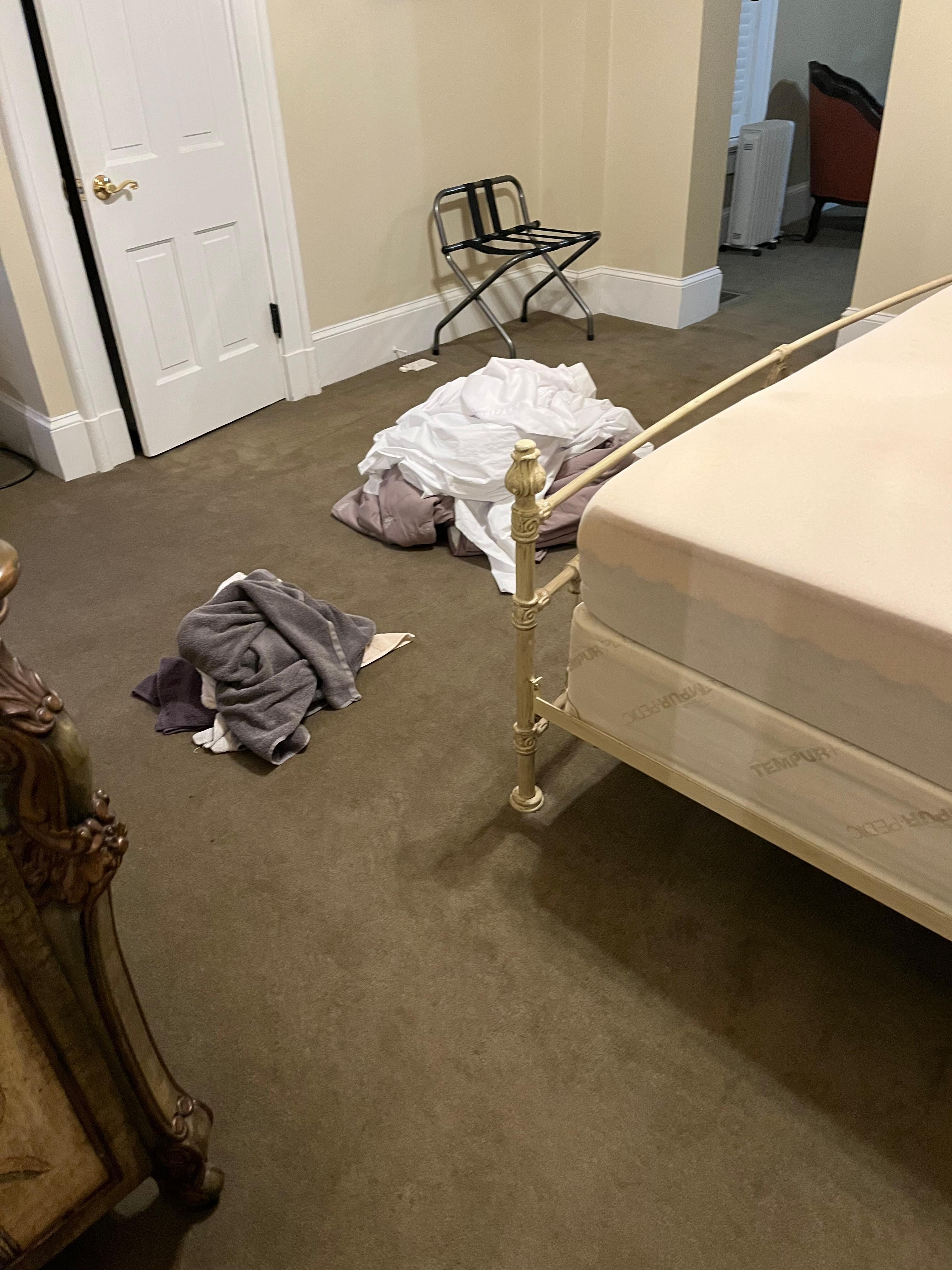 Dirty towels and sheets on the floor 
