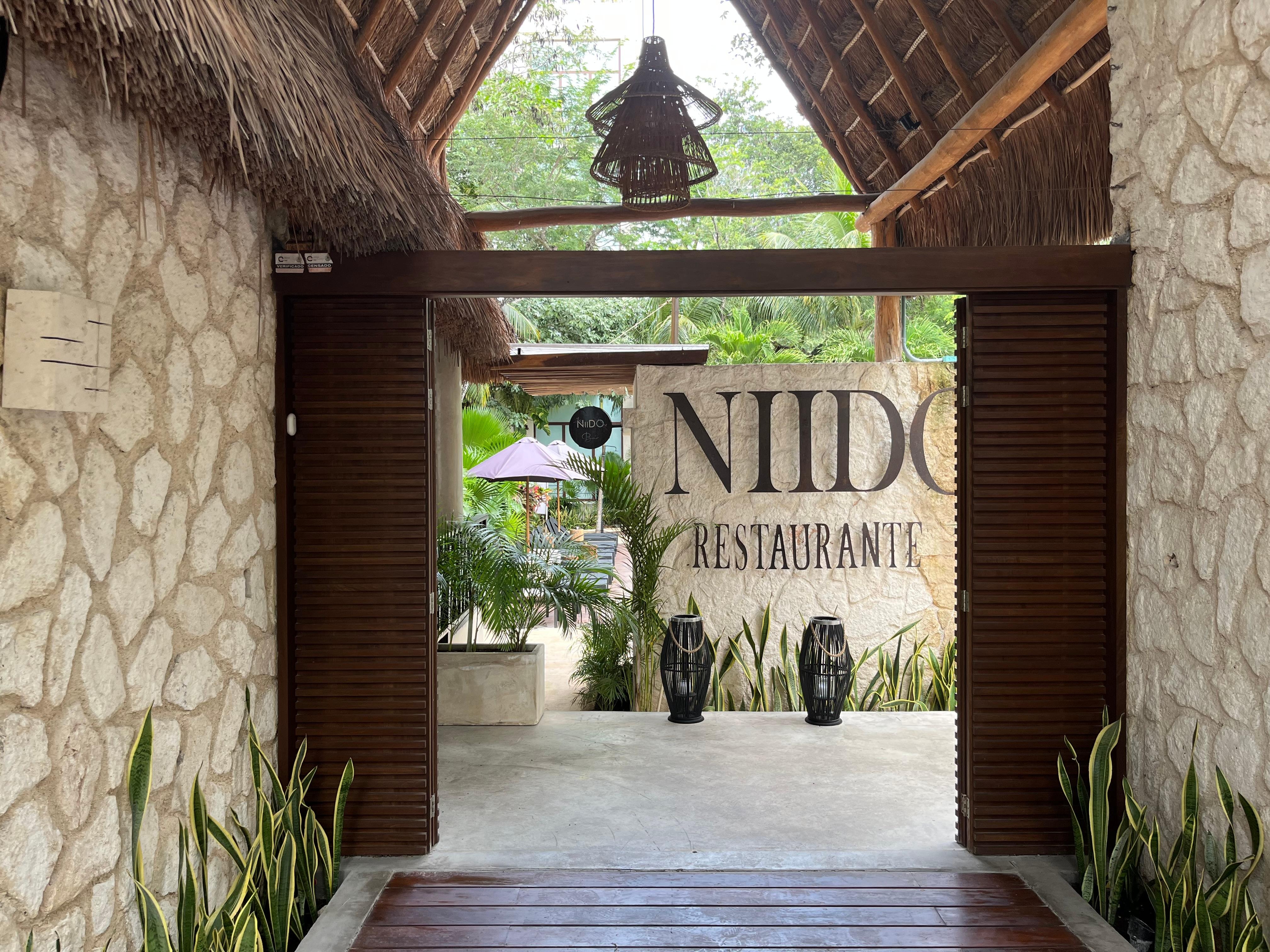 The front of the hotel with the restaurant name. 