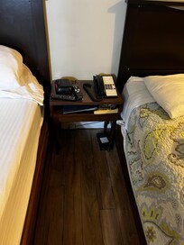 Bedside table with mouse trap underneath.