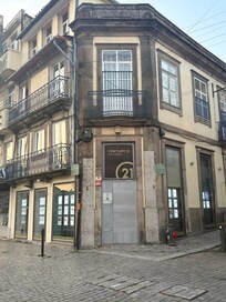 At the corner of the building/road