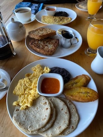Classic Guatemalan breakfast. Center plate is the best toasted coconut French toast + oat crusted French toasf