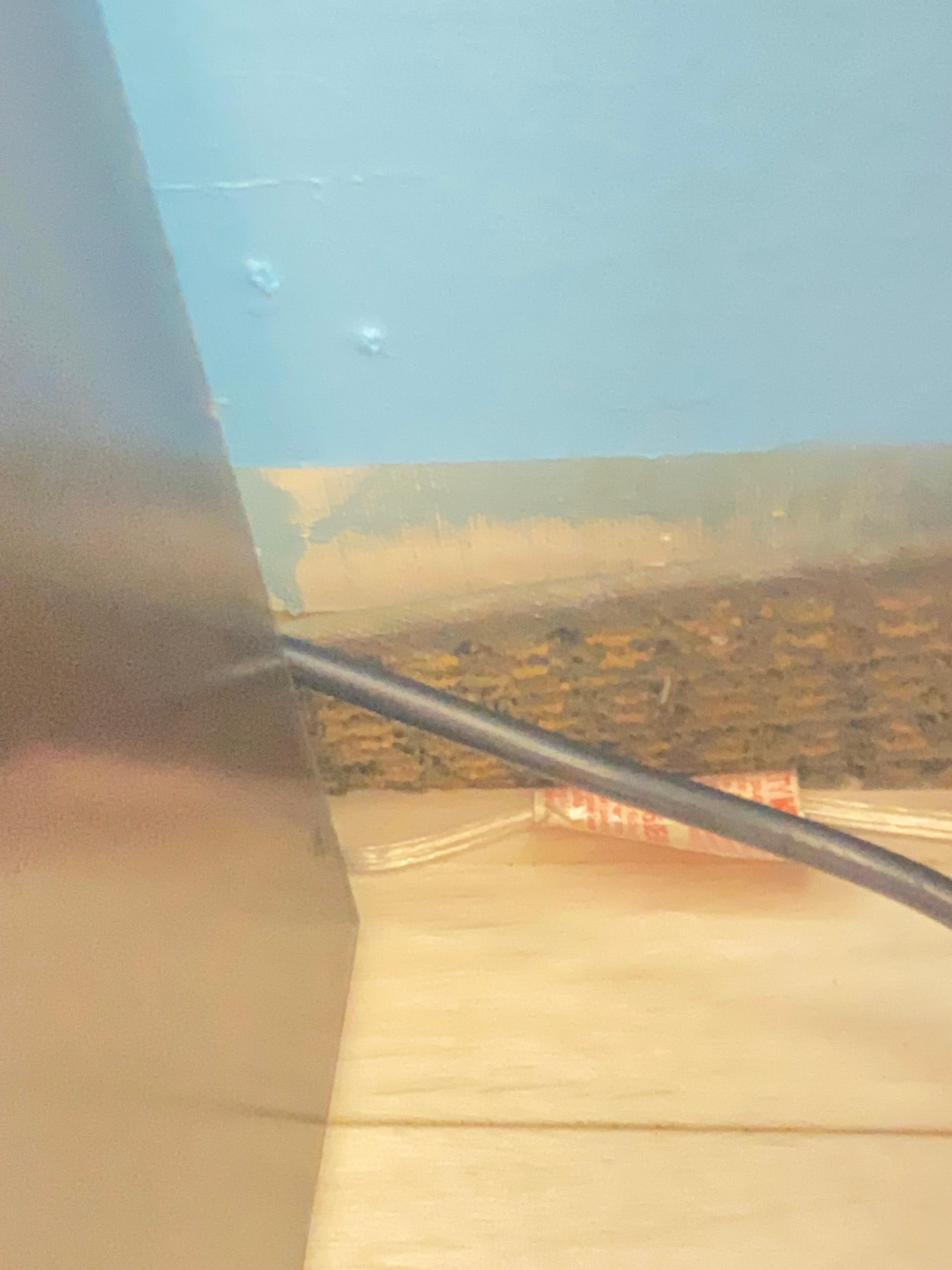 The wall peeling away from itself with cords hanging