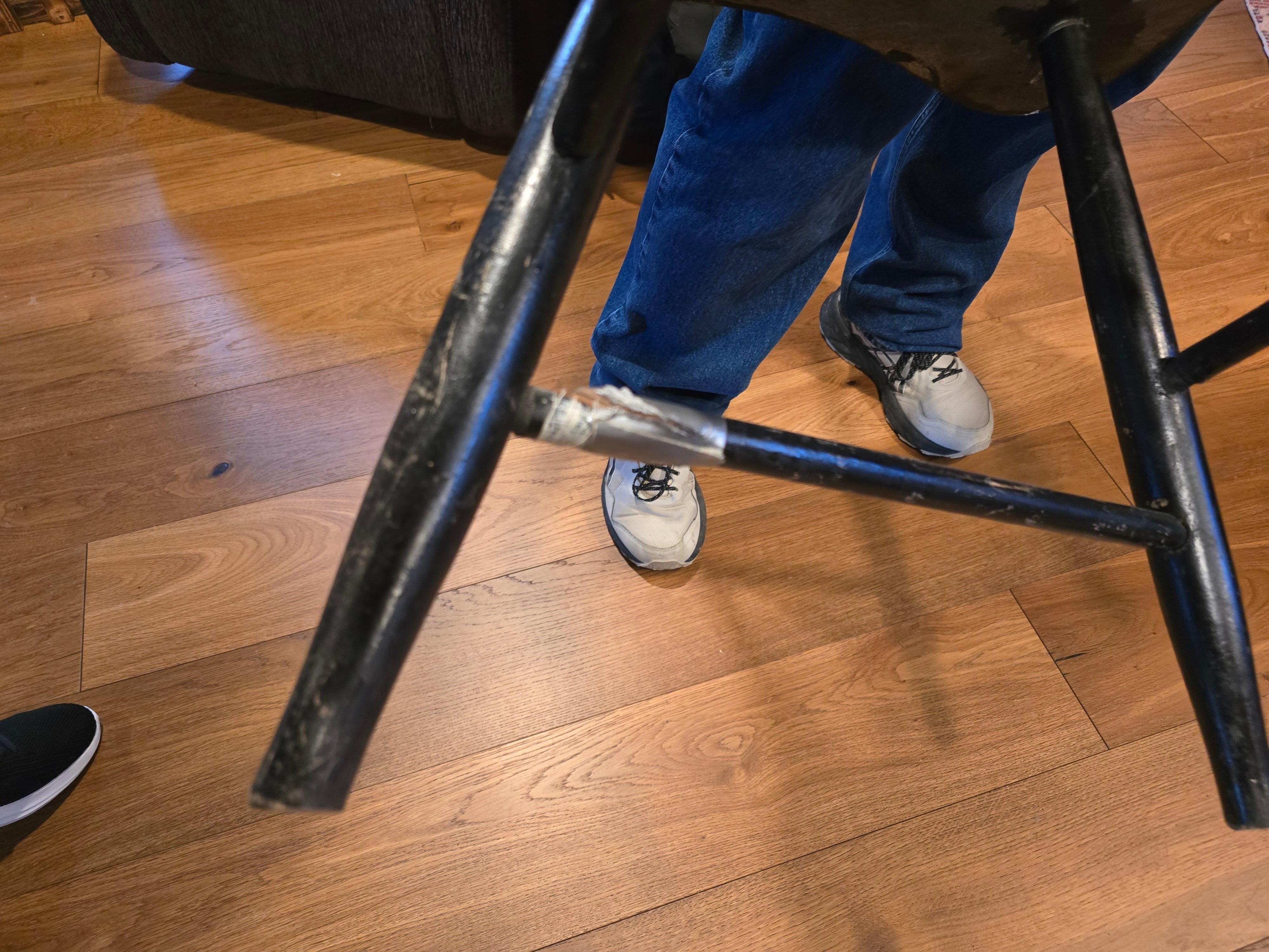 Chair taped together that a member of the group almost fell through.