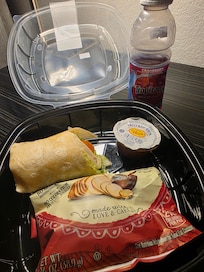 Snack/Beverage area - Half eaten Turkey, cheese wrap, sauce, and kettle chips-$10 and Cranberry Juice $3