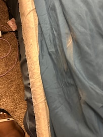 Linen on the bedding in the downstairs room with the balcony