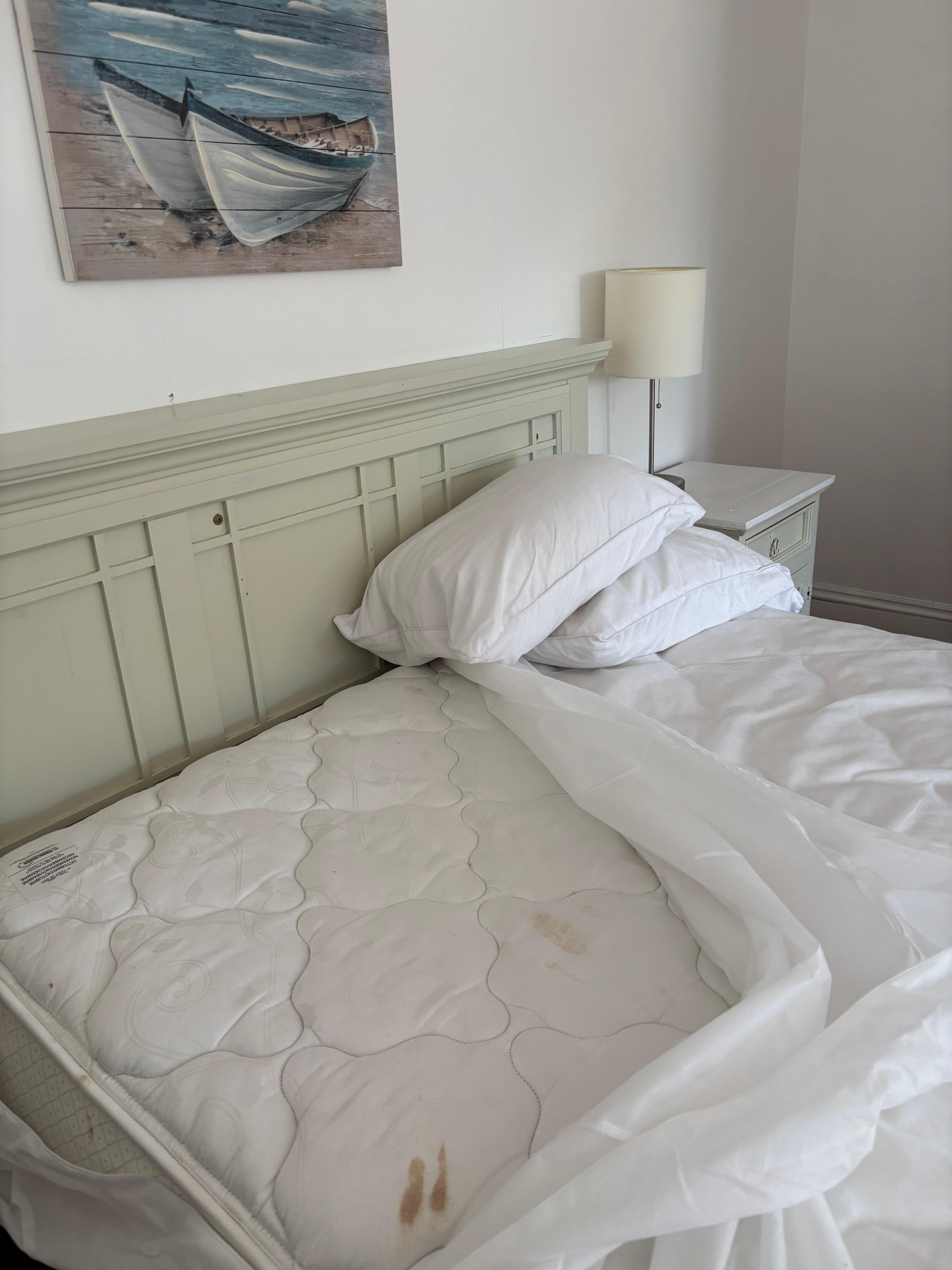 One of the many filthy mattresses. Blood stains maybe? Not sure 