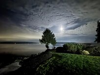 Night photo from backyard showing view with full moon