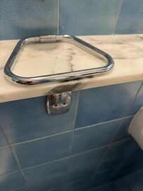 Metal fixture falling off wall