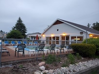 Pool went from inside to outside. There is a hot tub inside the building off the pool. Plenty of seating. :)