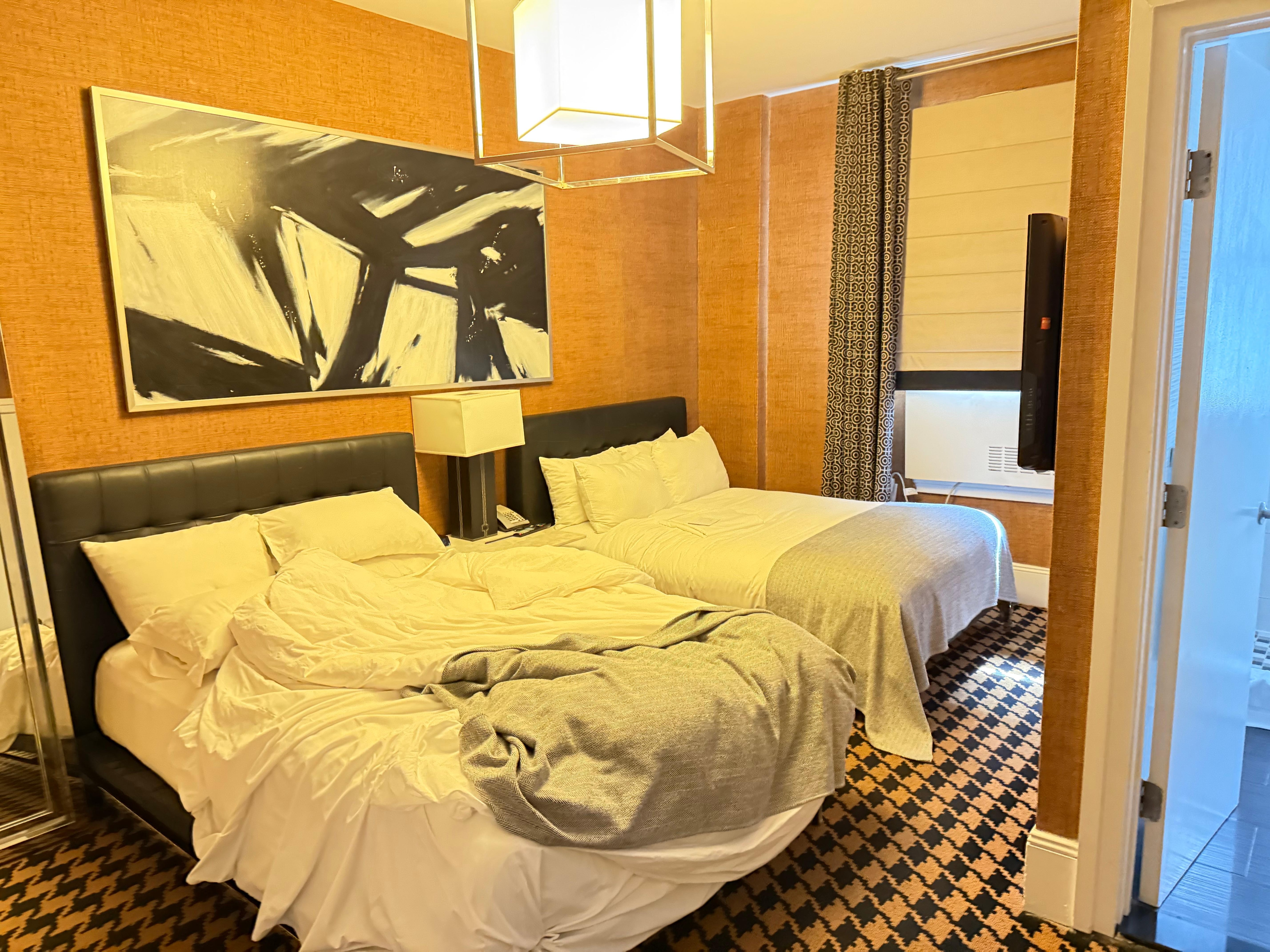 Tiny room. 2 double beds one chair.