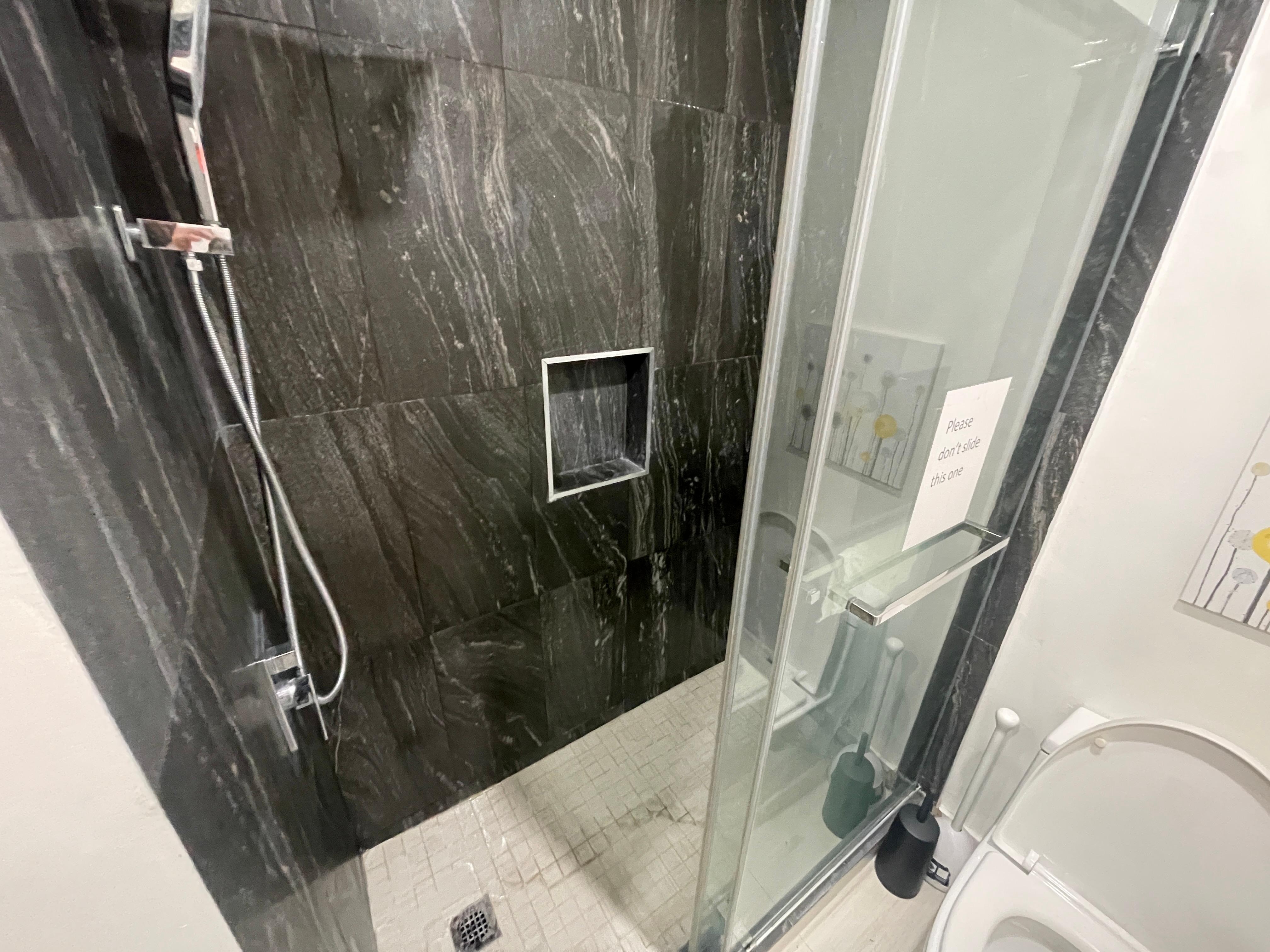 The shower has a rainfall and handheld head. And it has amazing water pressure.