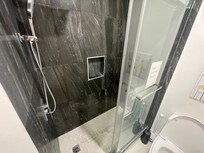 The shower has a rainfall and handheld head. And it has amazing water pressure.