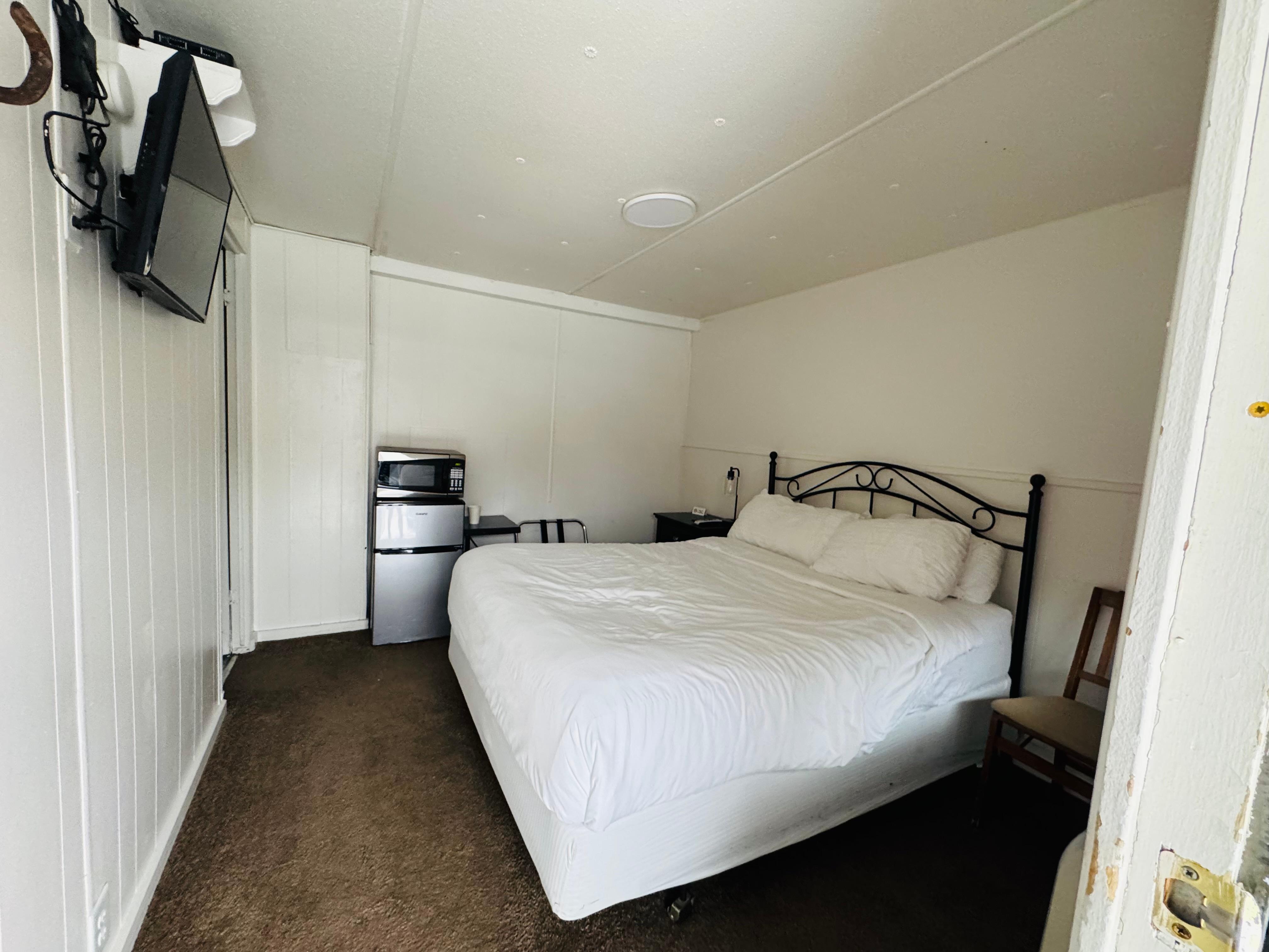 Our room (after ee checked out). Small, but very cozy and clean! There is a spacious bathroom on the left