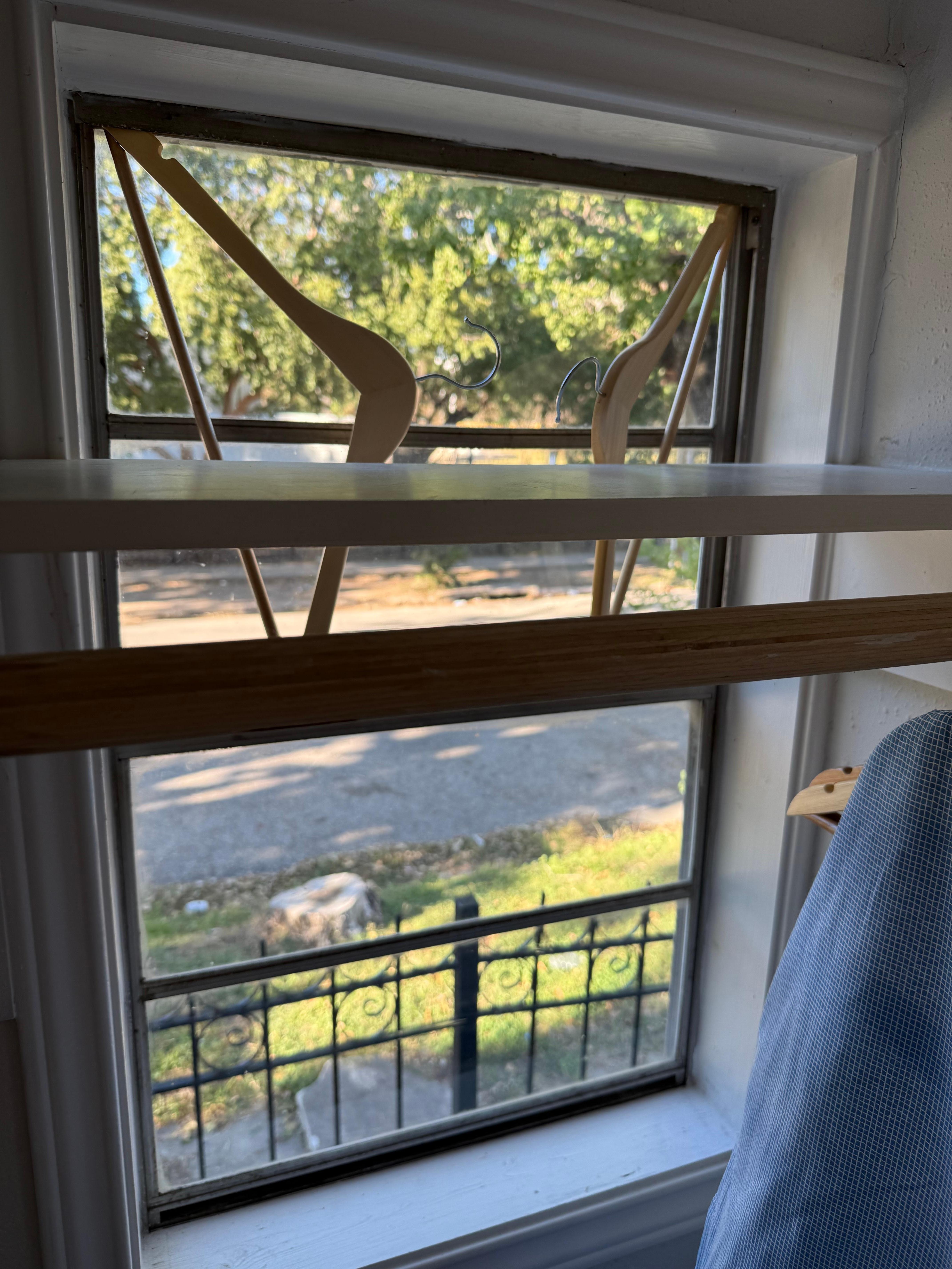Coat hangers in the window to “lock” the window