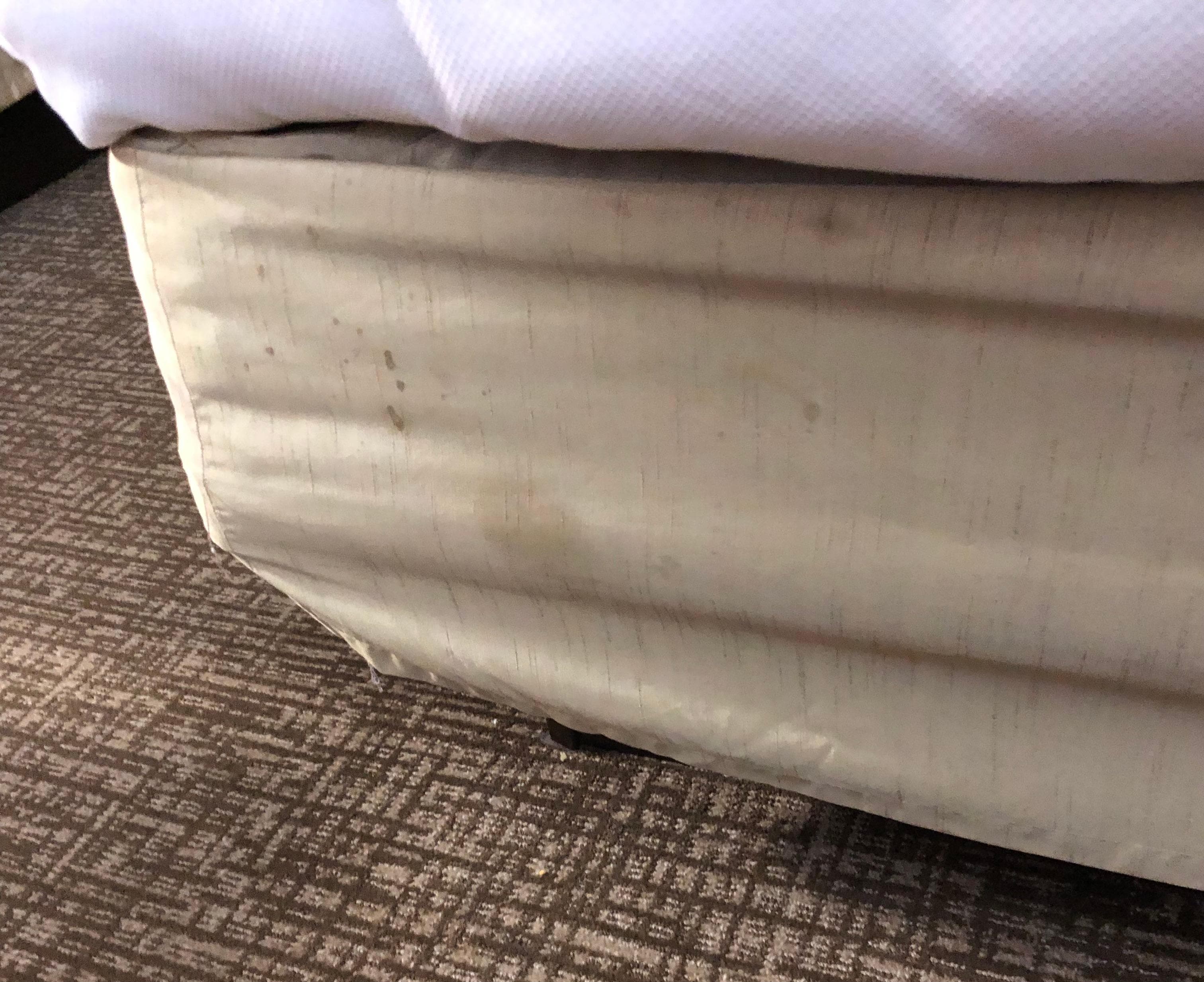 Another view of the stained and dirty covering for the base of the bed. 