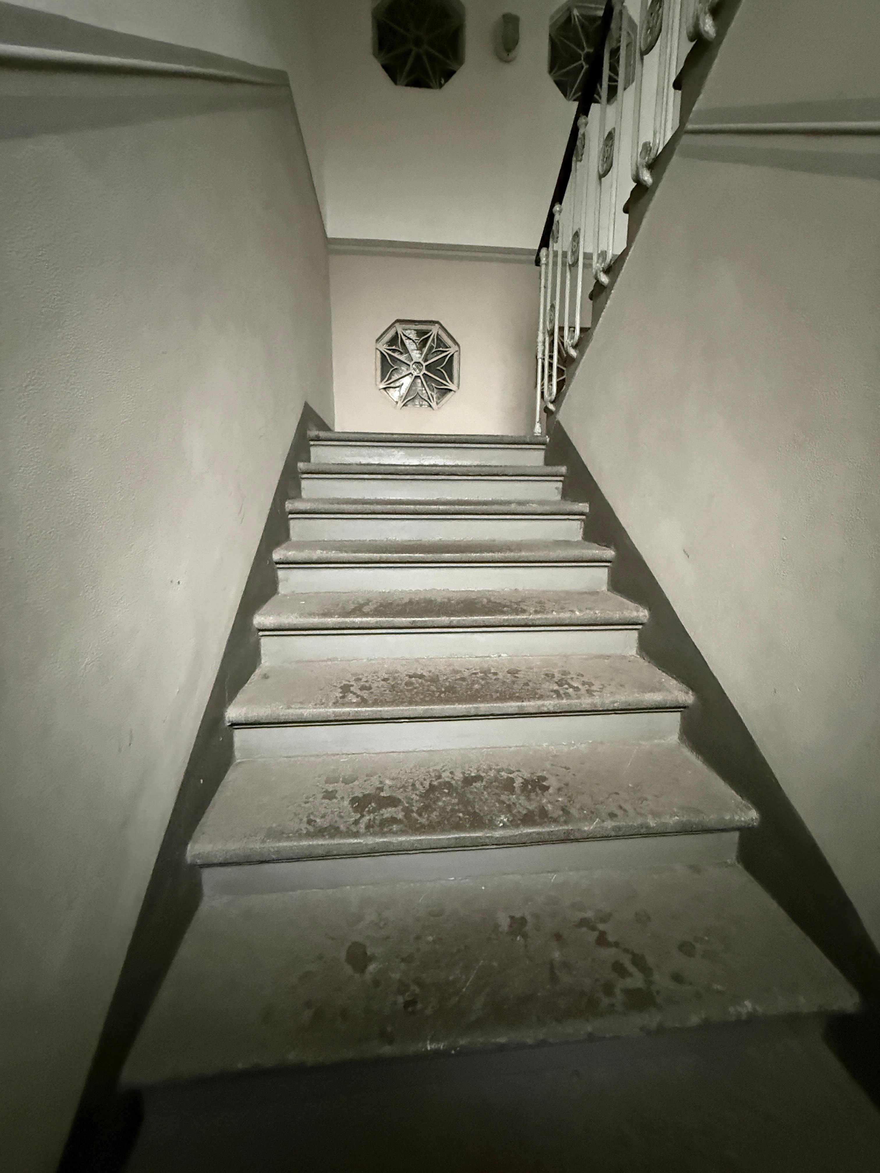 First flight of stairs upon entry 