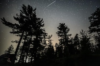 One meteor, cabin in lower left.