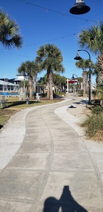 Paved path along the ocean and shops.